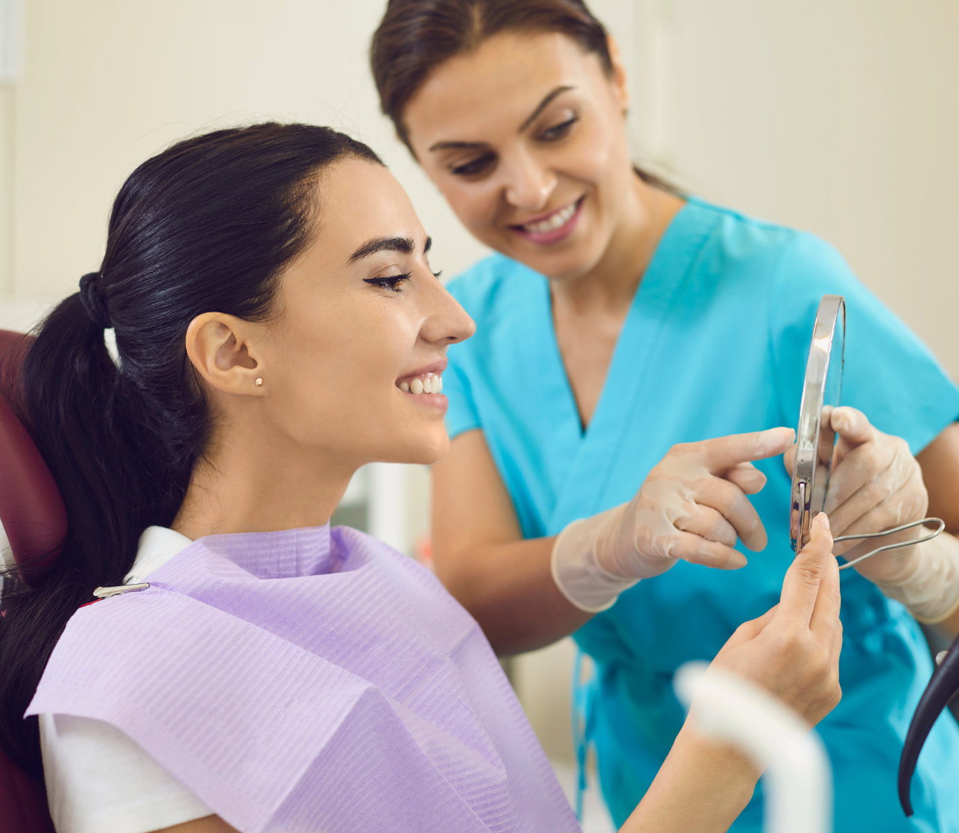 Happy Woman in Dental Chair Looking at the Result of Professional Teeth Cleaning and Whitening Happy Woman in Dental Chair Looking at the Result of Professional Teeth Cleaning and Whitening